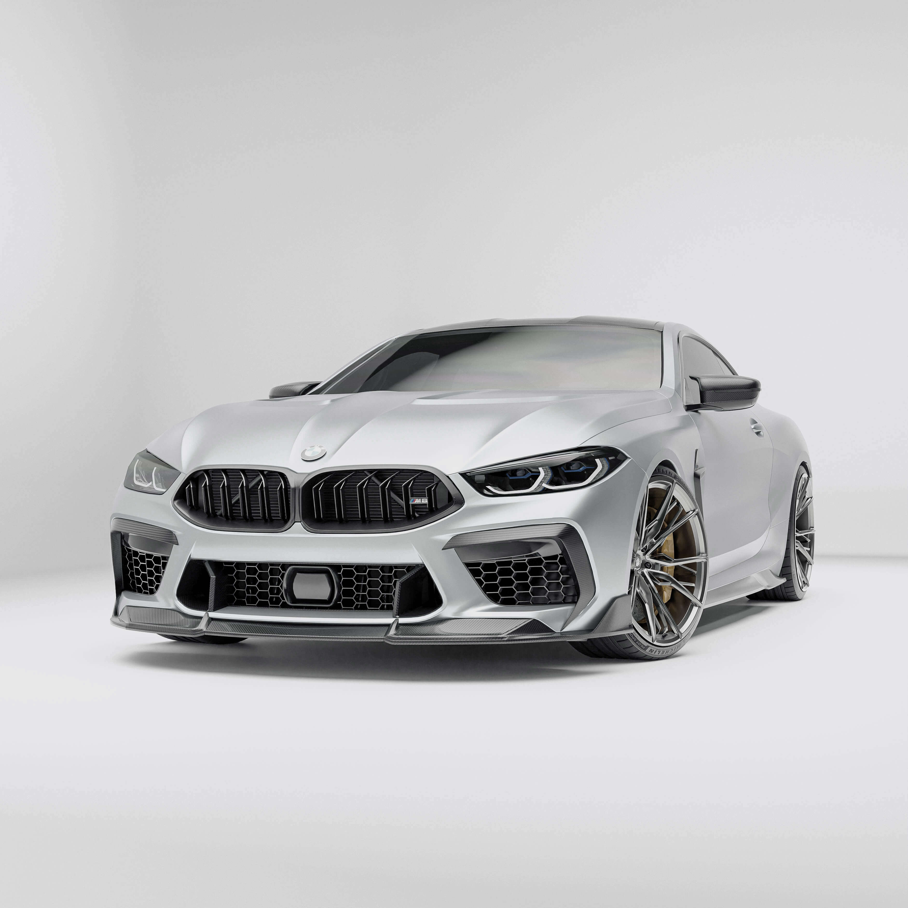 BMW M8 F92 with a carbon fiber front lip on a white background