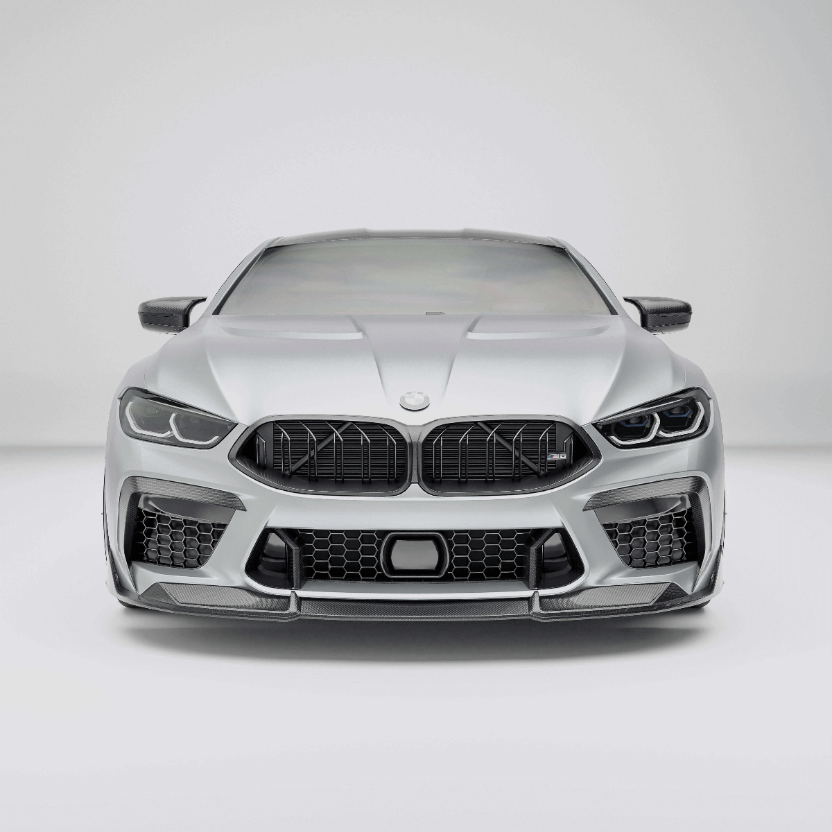 BMW M8 F92 with a carbon fiber grille on a white background