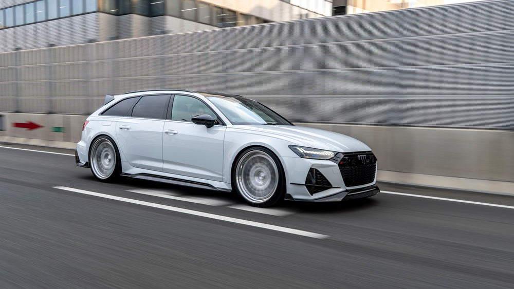 White Audi RS6 C8 Avant with RevoZport Street Program components driving in Japan