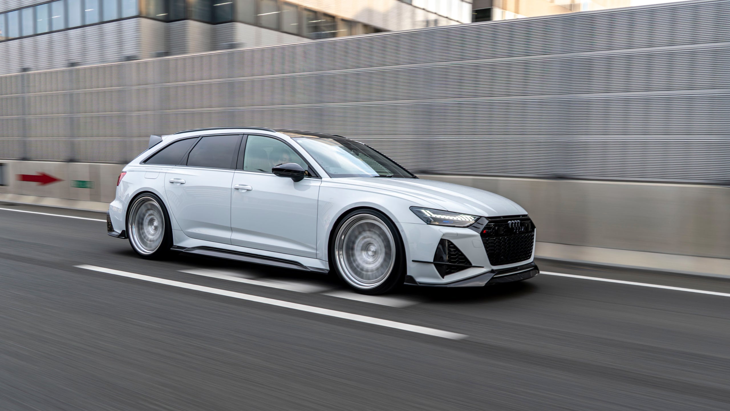 White Audi RS6 C8 Avant with RevoZport Street Program components driving in Japan