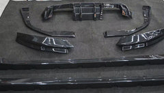 REVOZPORT glossy carbon fiber body kit components displayed before installation, including front lip sections, side skirts, rear diffuser, and aero trim pieces.