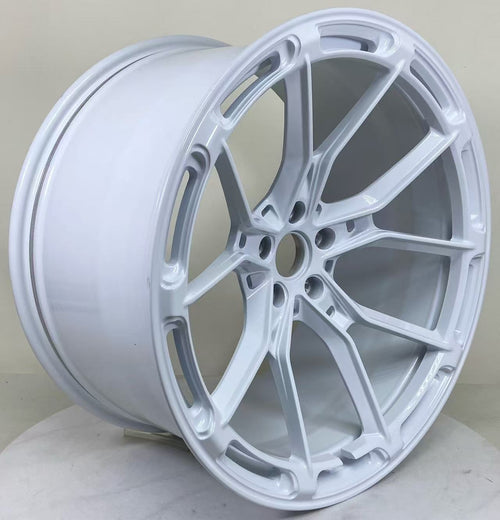 White REVOZPORT forged alloy wheel with lightweight split-spoke design displayed in a clean studio setting.