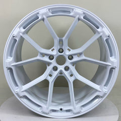 White REVOZPORT forged alloy wheel with lightweight split-spoke design displayed in a clean studio setting.