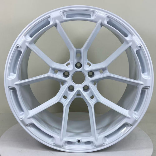 White REVOZPORT forged alloy wheel with lightweight split-spoke design displayed in a clean studio setting.