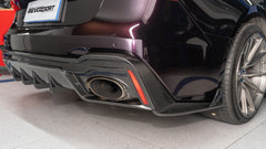 Black Audi RS7 featuring a REVOZPORT carbon fiber body kit with front lip, side skirts, carbon hood, and aggressive aero styling driving on a city street.