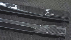 REVOZPORT glossy carbon fiber body kit components displayed before installation, including front lip sections, side skirts, rear diffuser, and aero trim pieces.