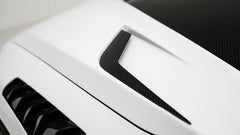 White BMW G80 M3 featuring a REVOZPORT carbon fiber body kit with front lip, side skirts, canards, vented fenders, and yellow DRL headlights displayed in a clean studio setting.