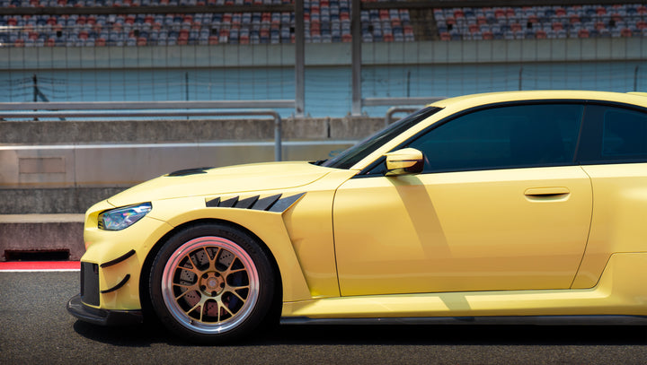 Yellow BMW M2 G87 front wheel and side view