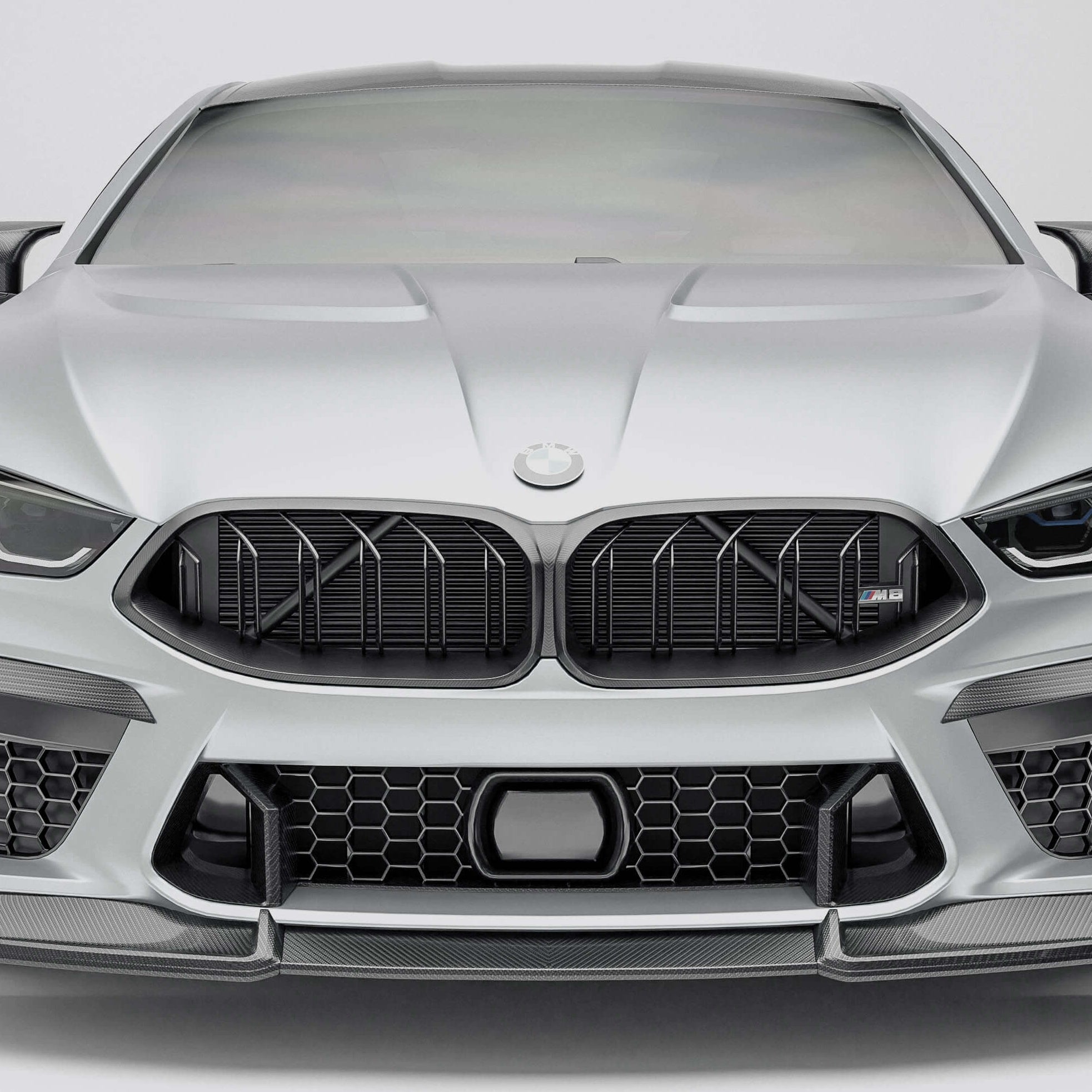 BMW M8 F92  with a carbon fiber griile close-up  on a white background