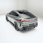 bmw-x6-g06:-top-down-view-of-the-carbon-fiber-body-kit-against-a-gray-background