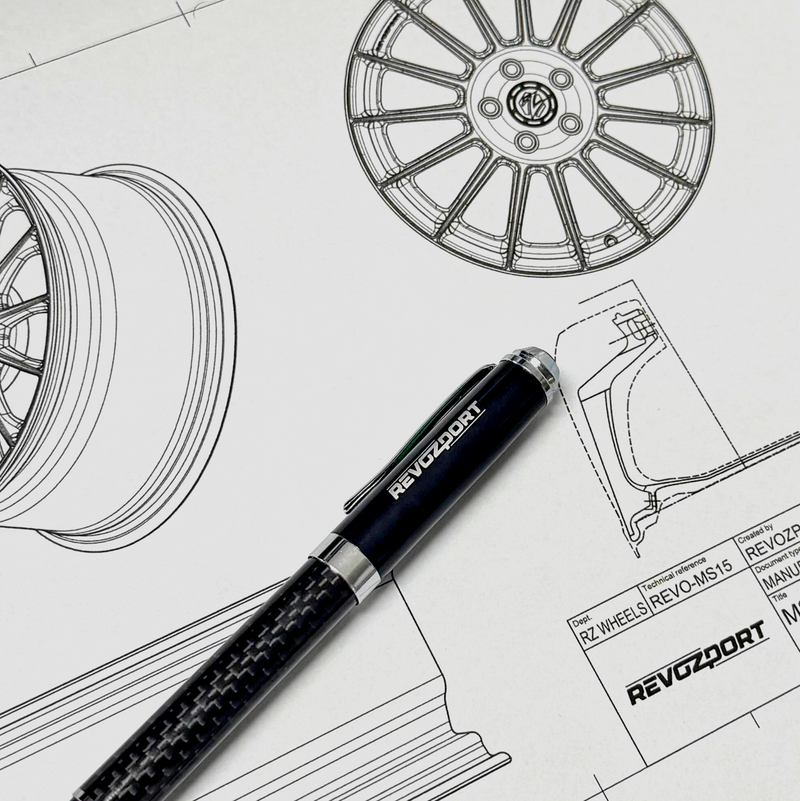REVO wheel hub design drawings and a carbon fibre pen